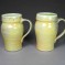 Multi-colored mustard mugs with green glaze inside, stoneware.