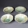 Fluted green porcelain bowls with brown highlights.