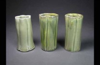 Trio of green porcelain fluted vases.